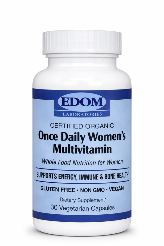 A white bottle of EDOM Laboratories Once Daily Women’s Whole Food Multivitamin featuring the blue oval EDOM logo, certified organic text, and label details for whole‑food nutrition, energy, immune, and bone health support.
